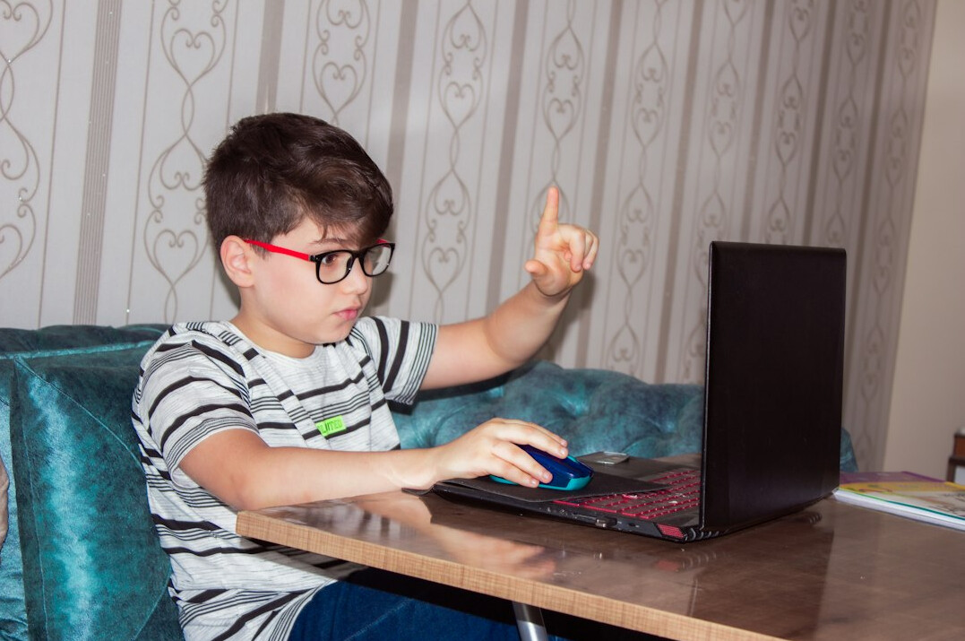 kids coding on laptops