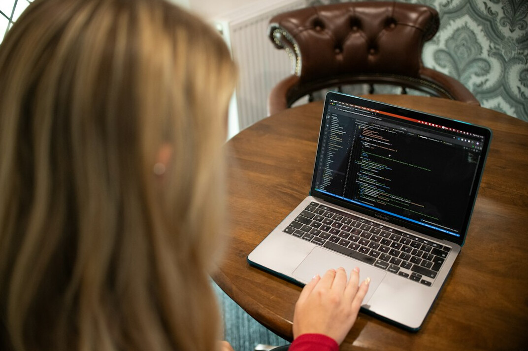 student learning coding on laptop