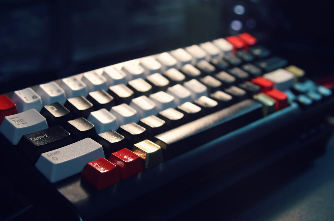 Close-up of hands typing on a mechanical keyboard