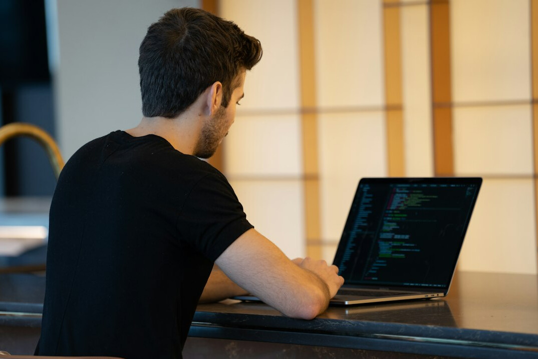 programmer learning code on laptop
