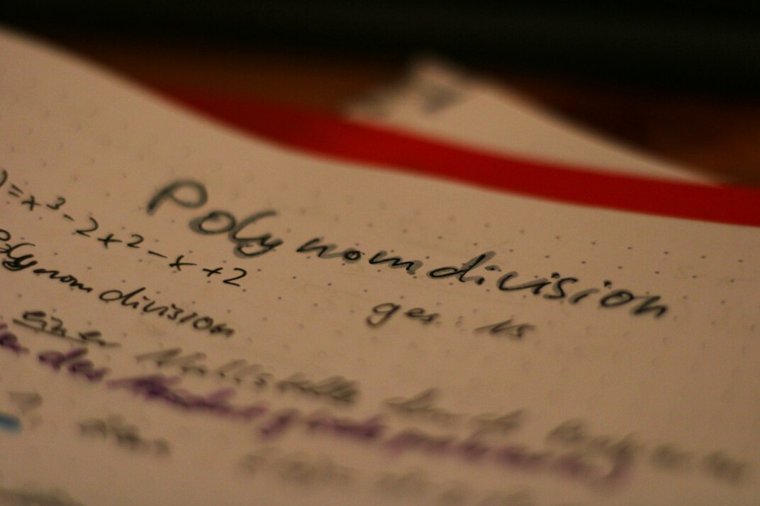 Open notebook with handwritten pseudocode and a pen